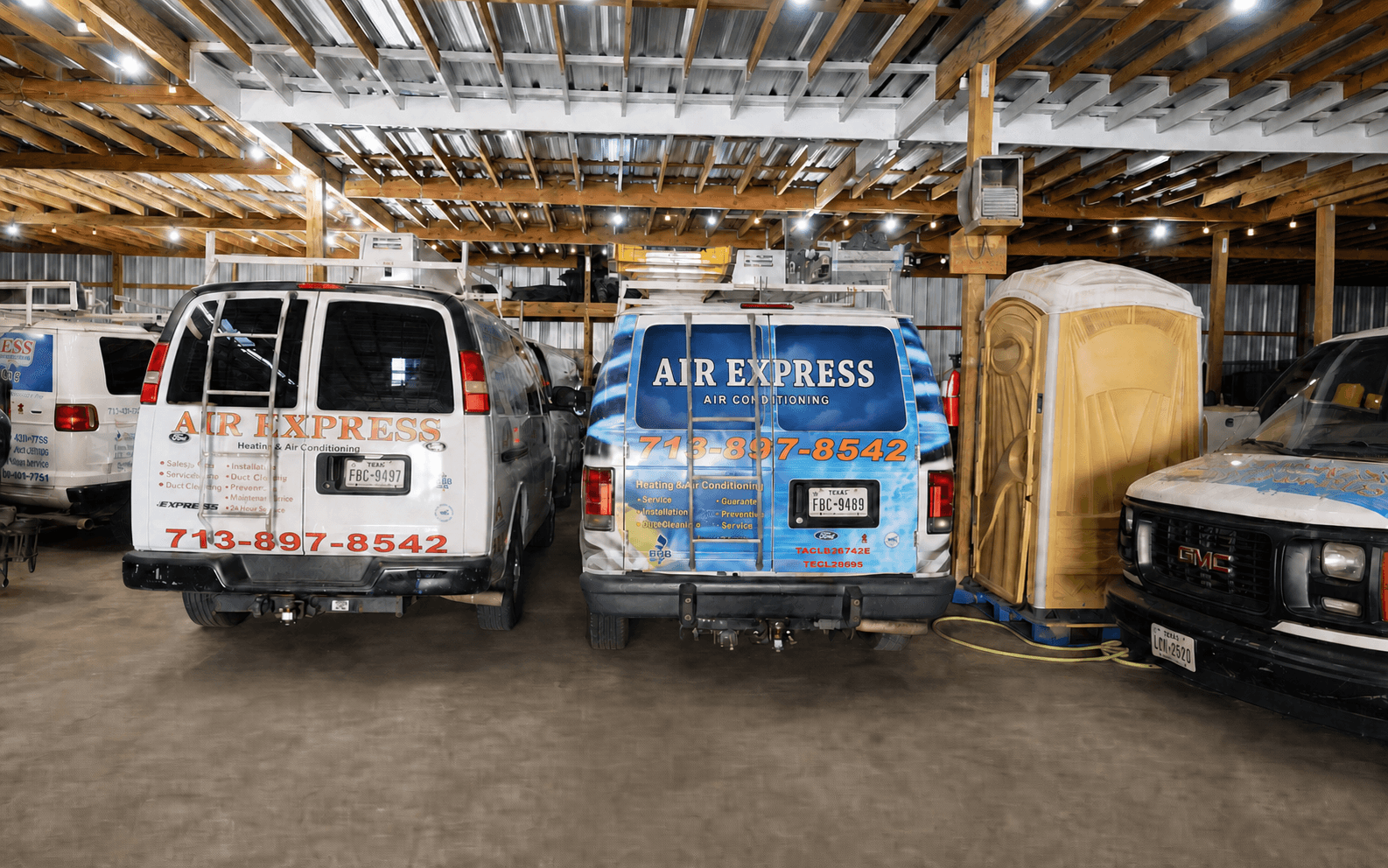 Air Express service vehicles parked inside the company workshop